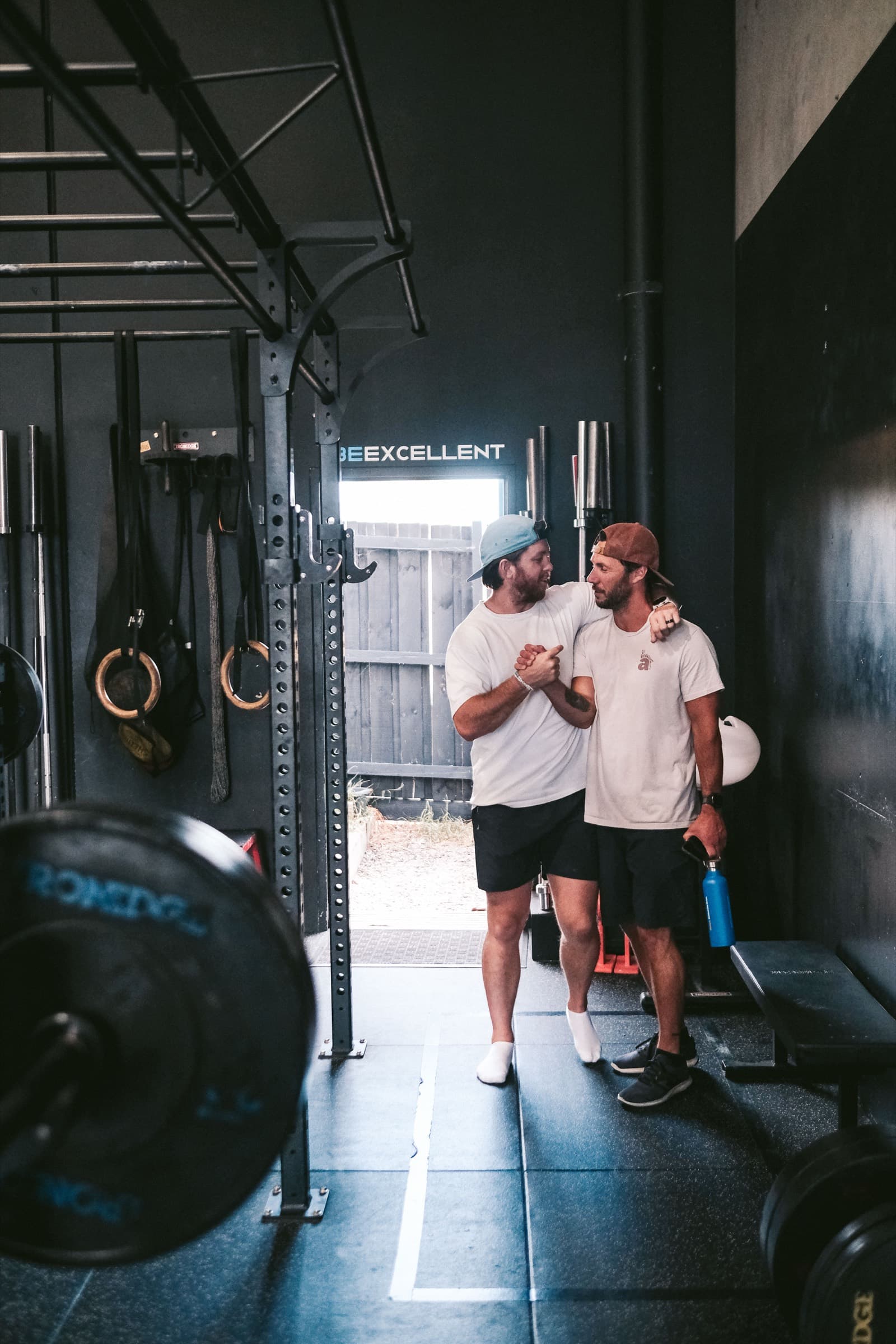 A coach and member sharing a relaxed moment on the Virtus floor
