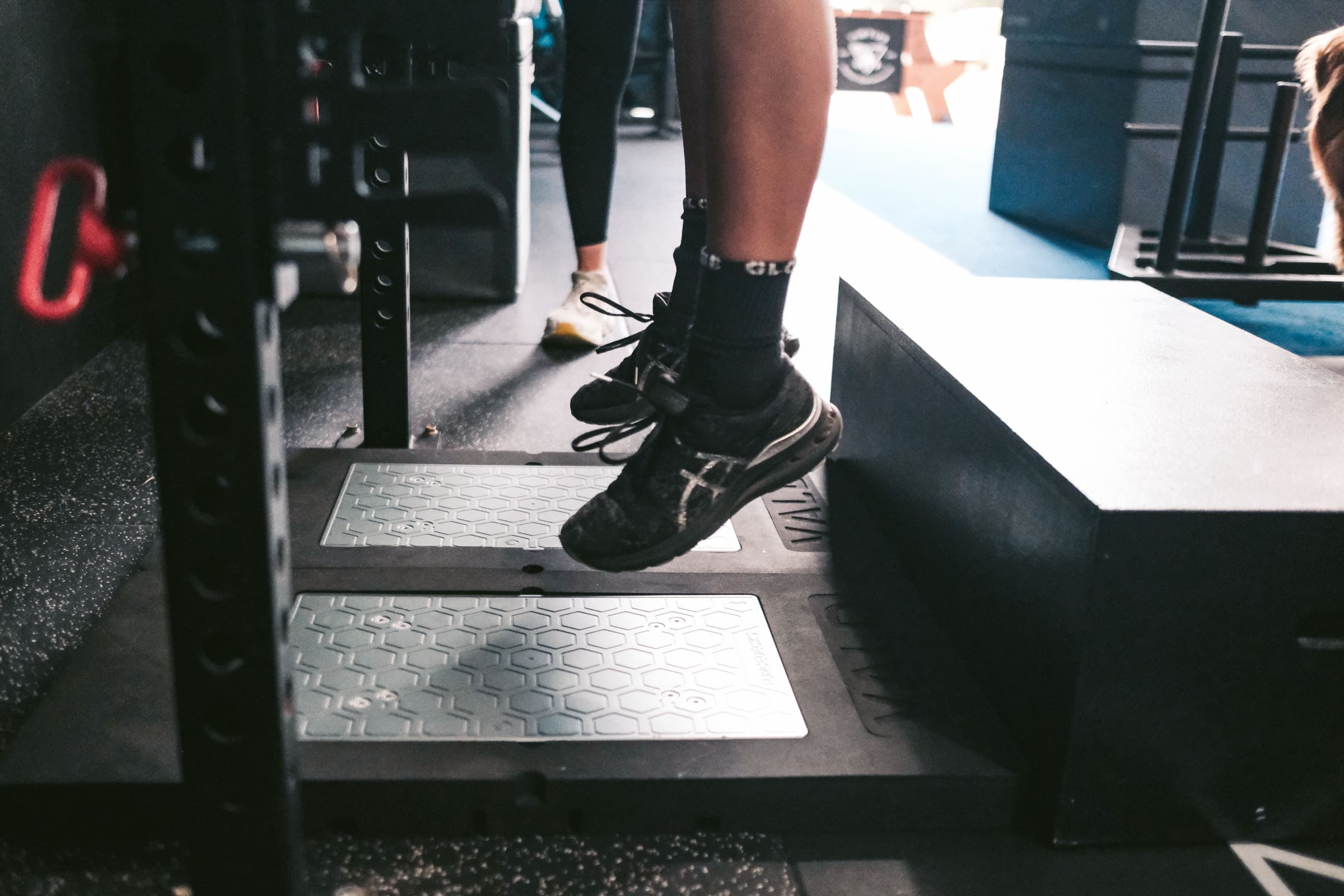 A member completing a measured jump test on the Virtus floor
