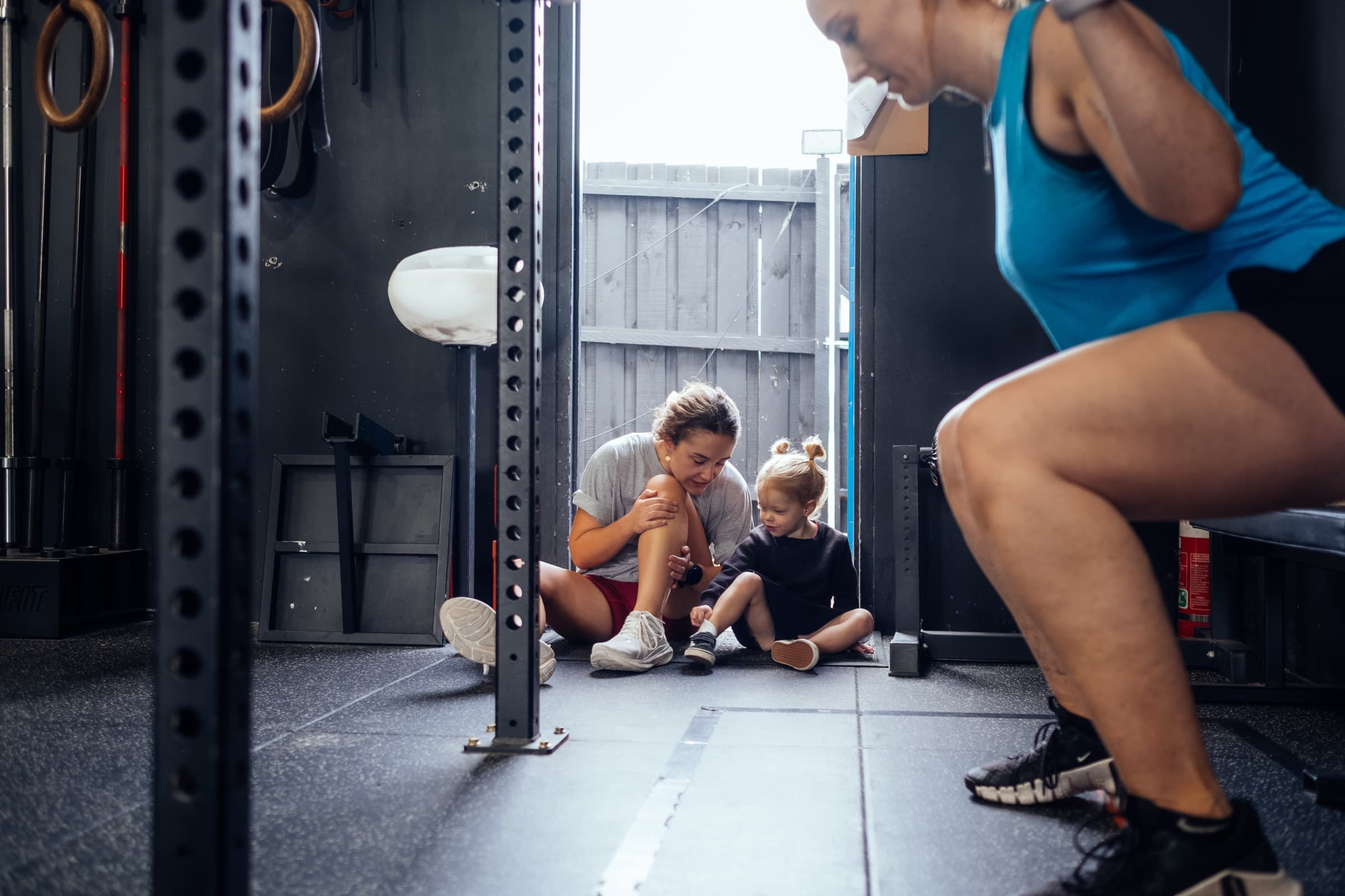 A woman strength training with coaching at Virtus